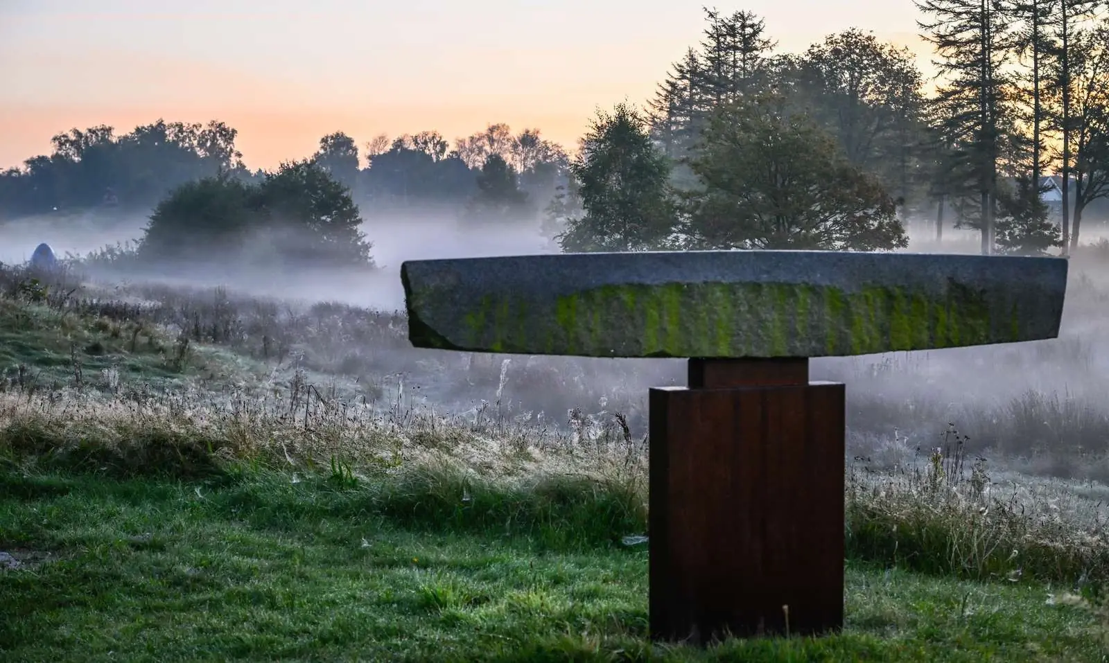 Stone sculpture in Billund Sculpture Park on a misty morning
