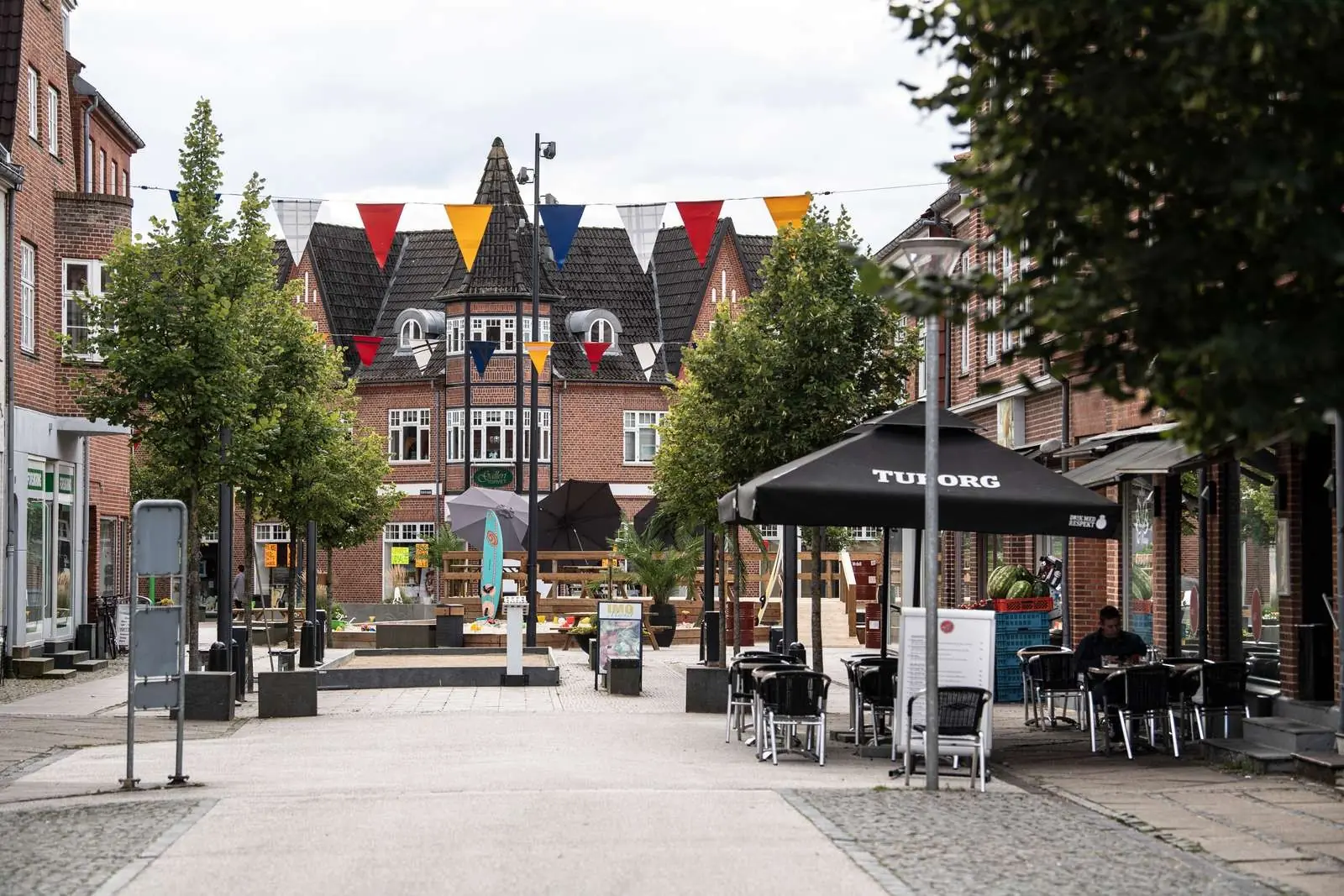 Town square in Grindsted with colourful bunting and café tables